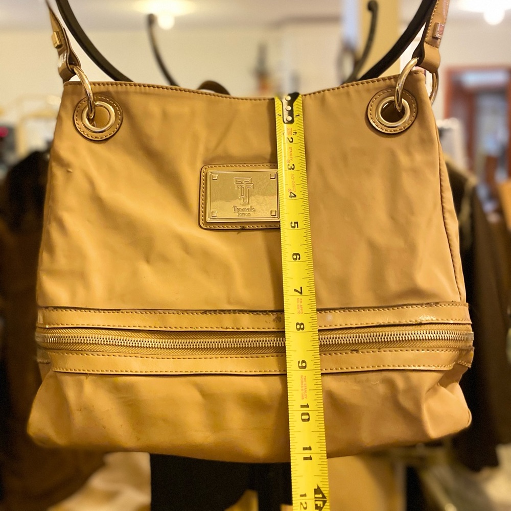 Tignanello, duo compartment, bucket style, zipper area below, a good baby bag.